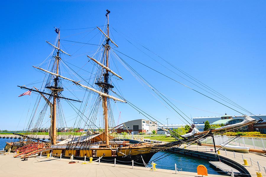 About Our Agency - USS Niagara Ship, an Old Wooden Ship in the Shipyard of Erie, Pennsylvania, on a Cloudless Day